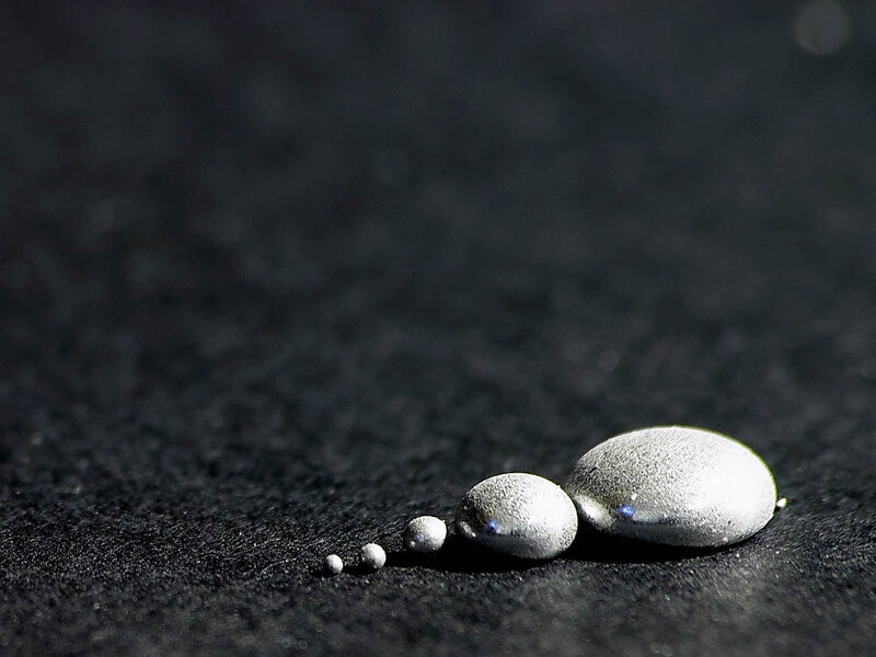 Mercury droplets on dark surface