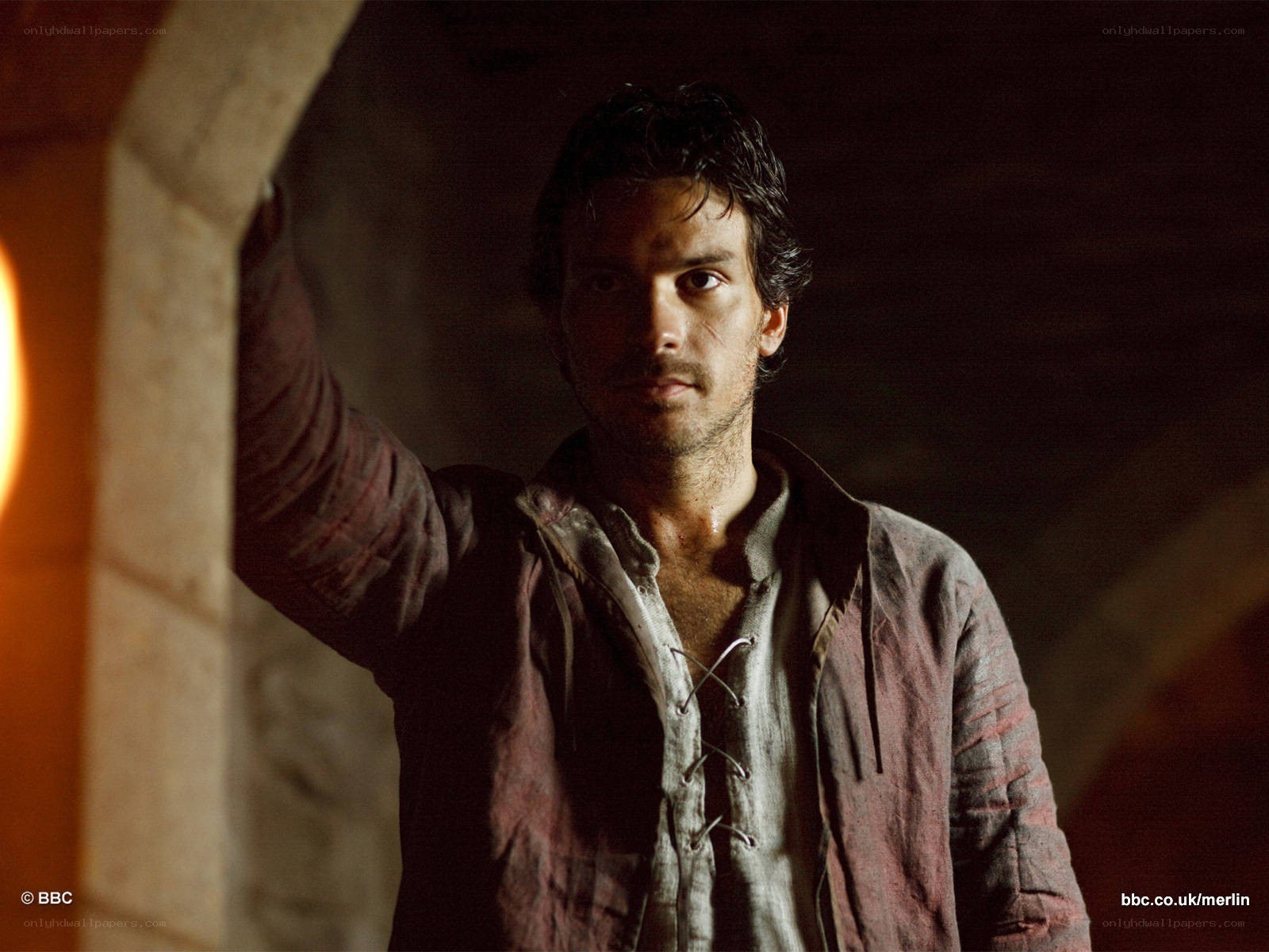 Merlin character in dimly lit room