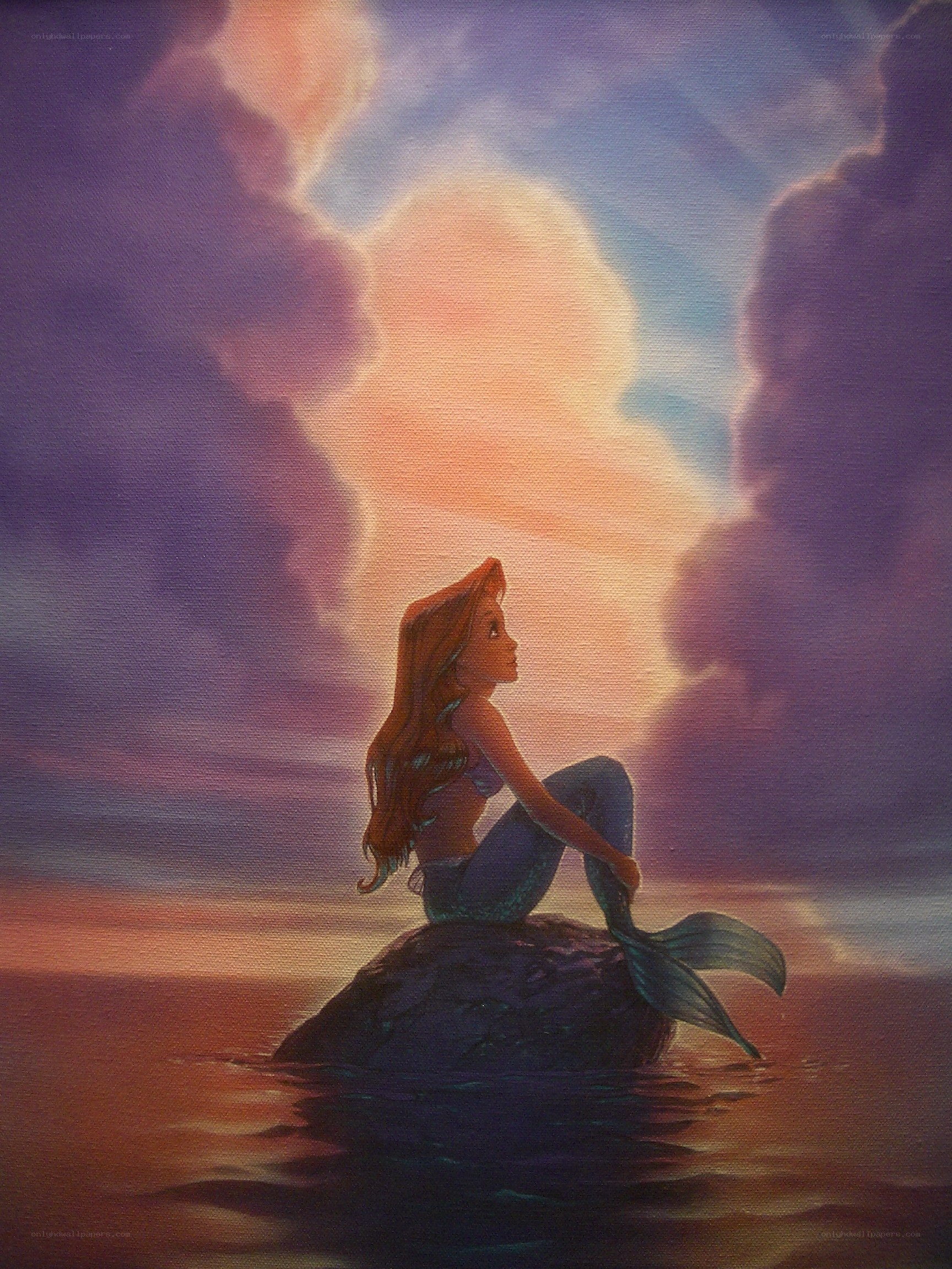 mermaid on a rock at sunset