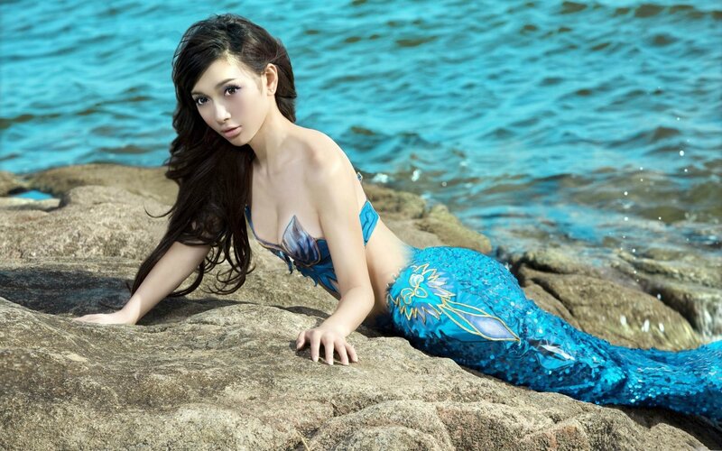 mermaid on rocky shore