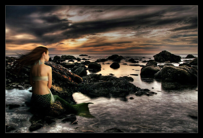 mermaid on rocky shore