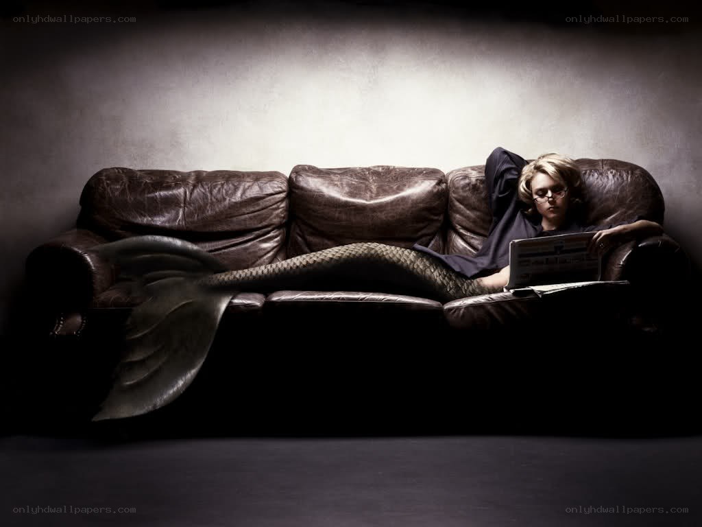 mermaid reading on a couch
