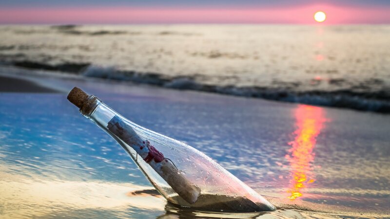 message in a bottle at sunset