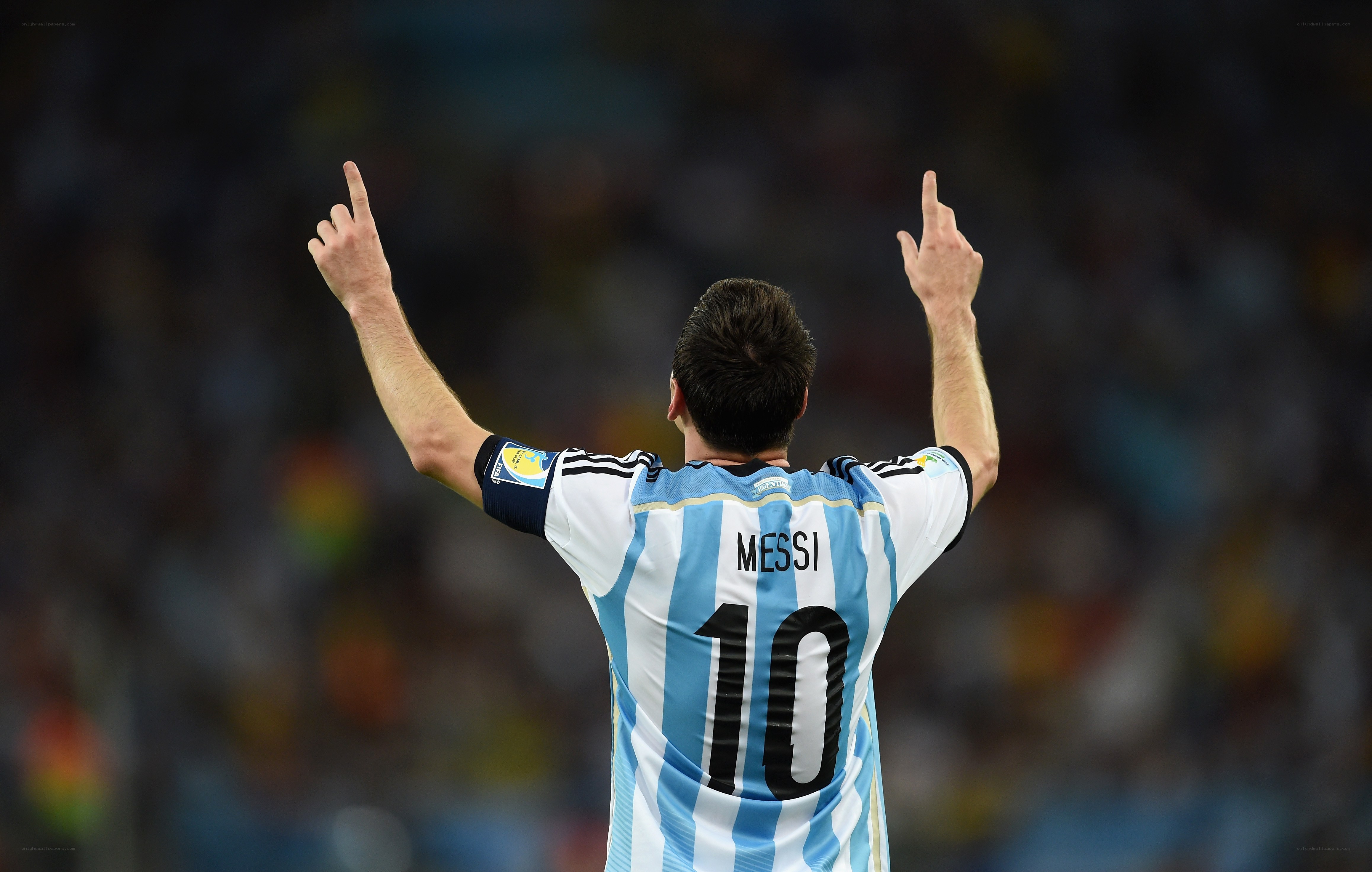 Messi celebrates with arms raised