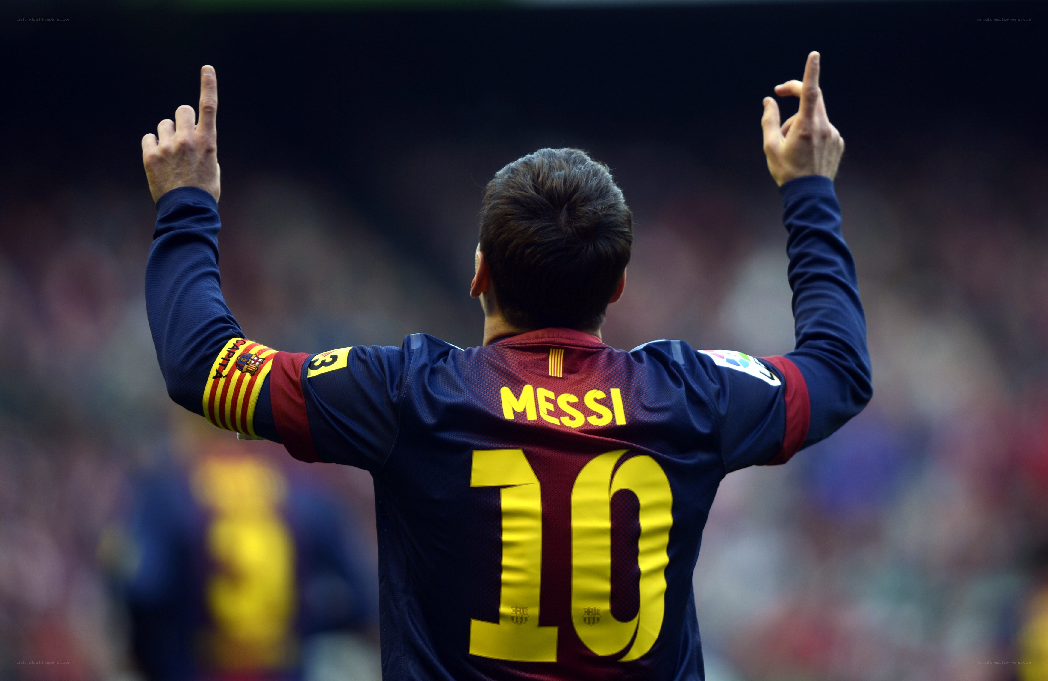 Messi celebrating with hands up
