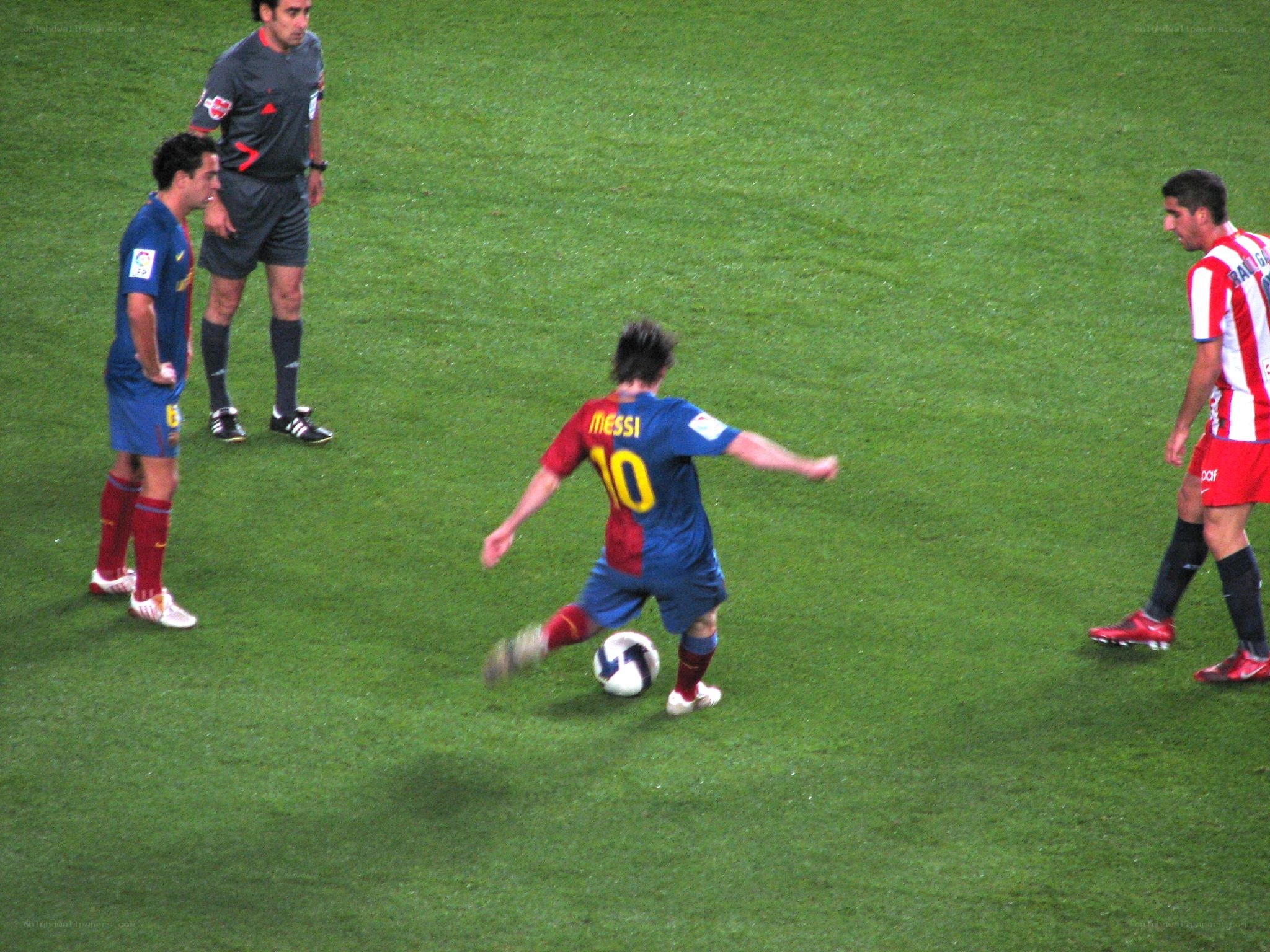 Messi playing soccer on field