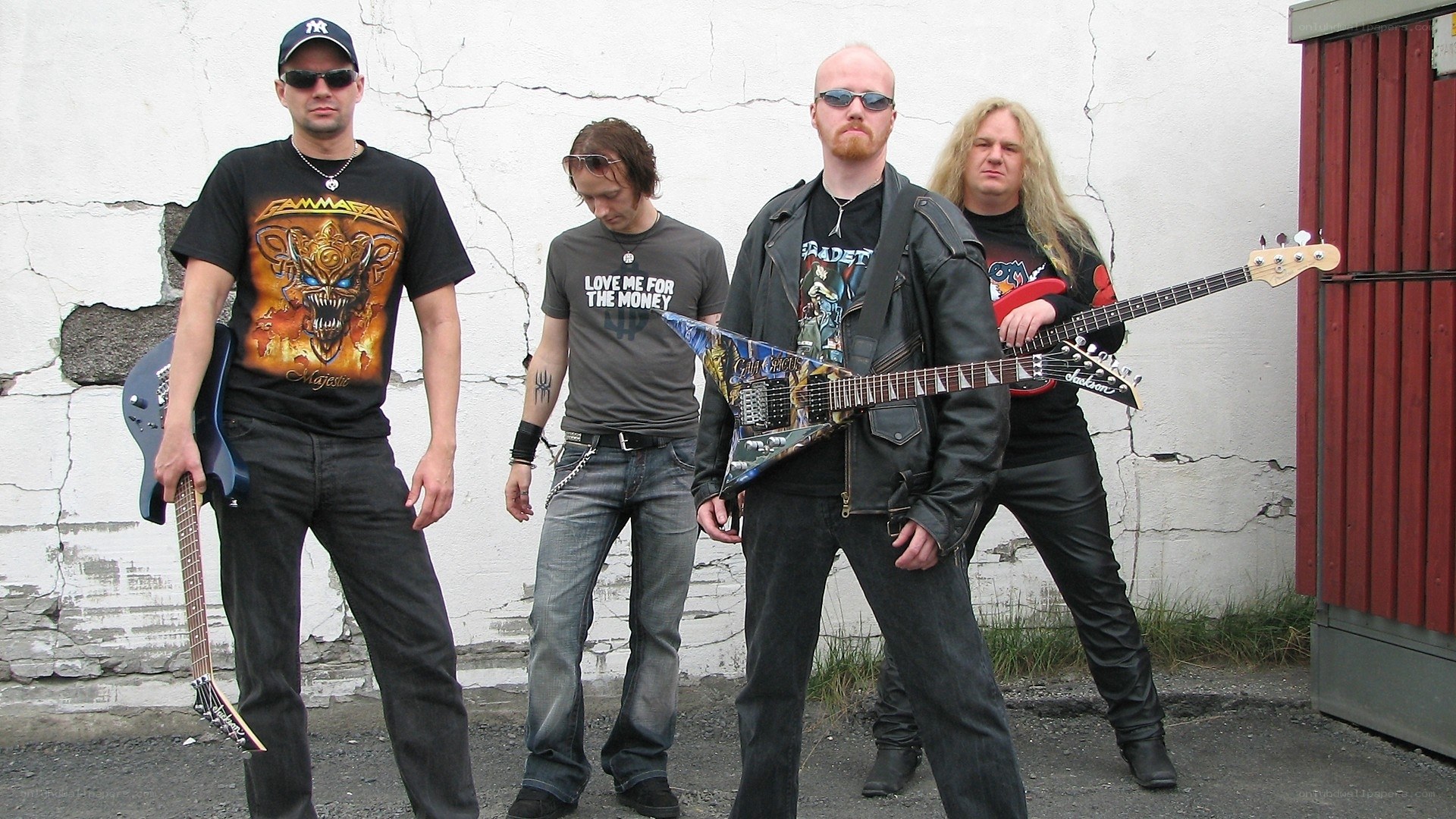 metal band posing with guitars