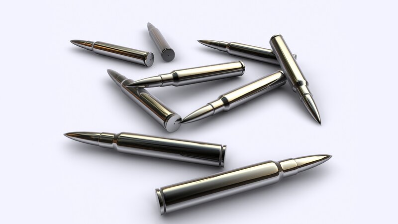 Metal bullets on white surface