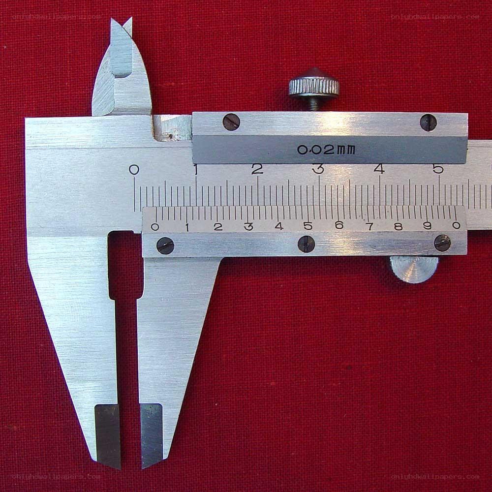 metal caliper on red fabric