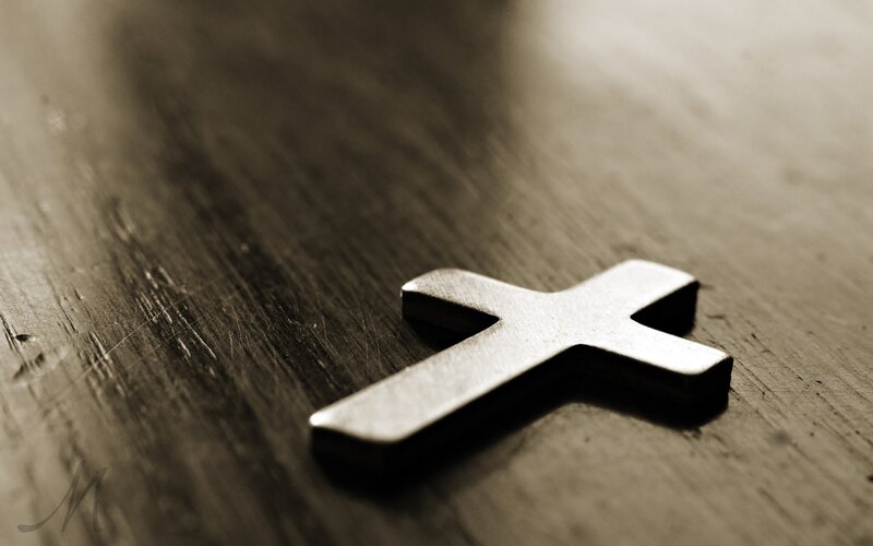 Metal Cross on Wood