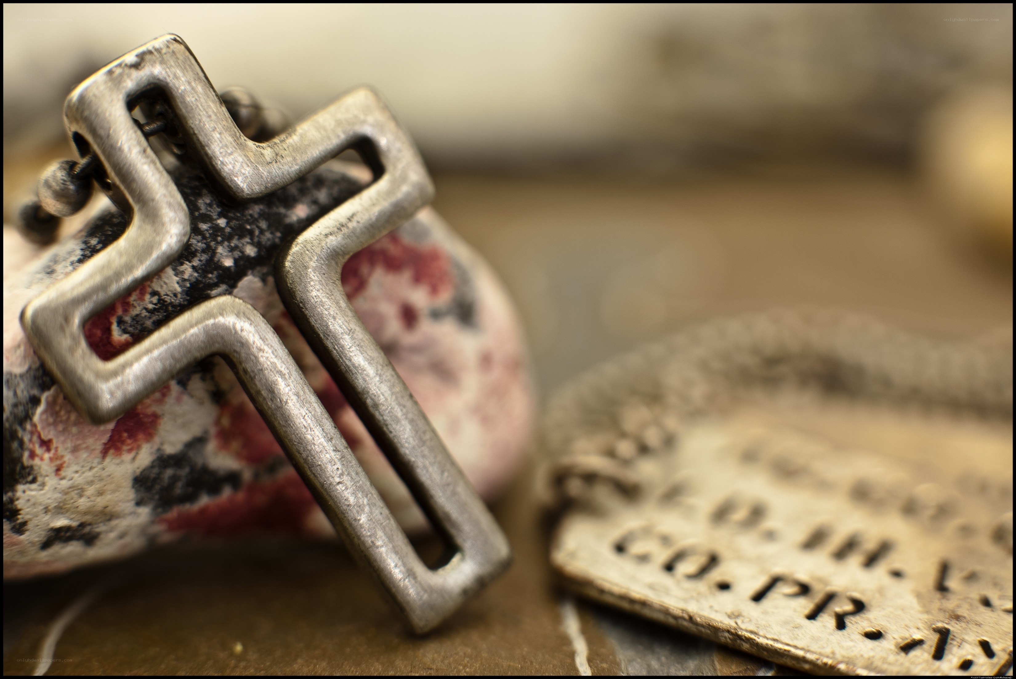 metal cross pendant on stone