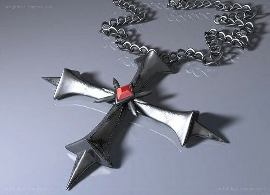 metal cross pendant with red gem