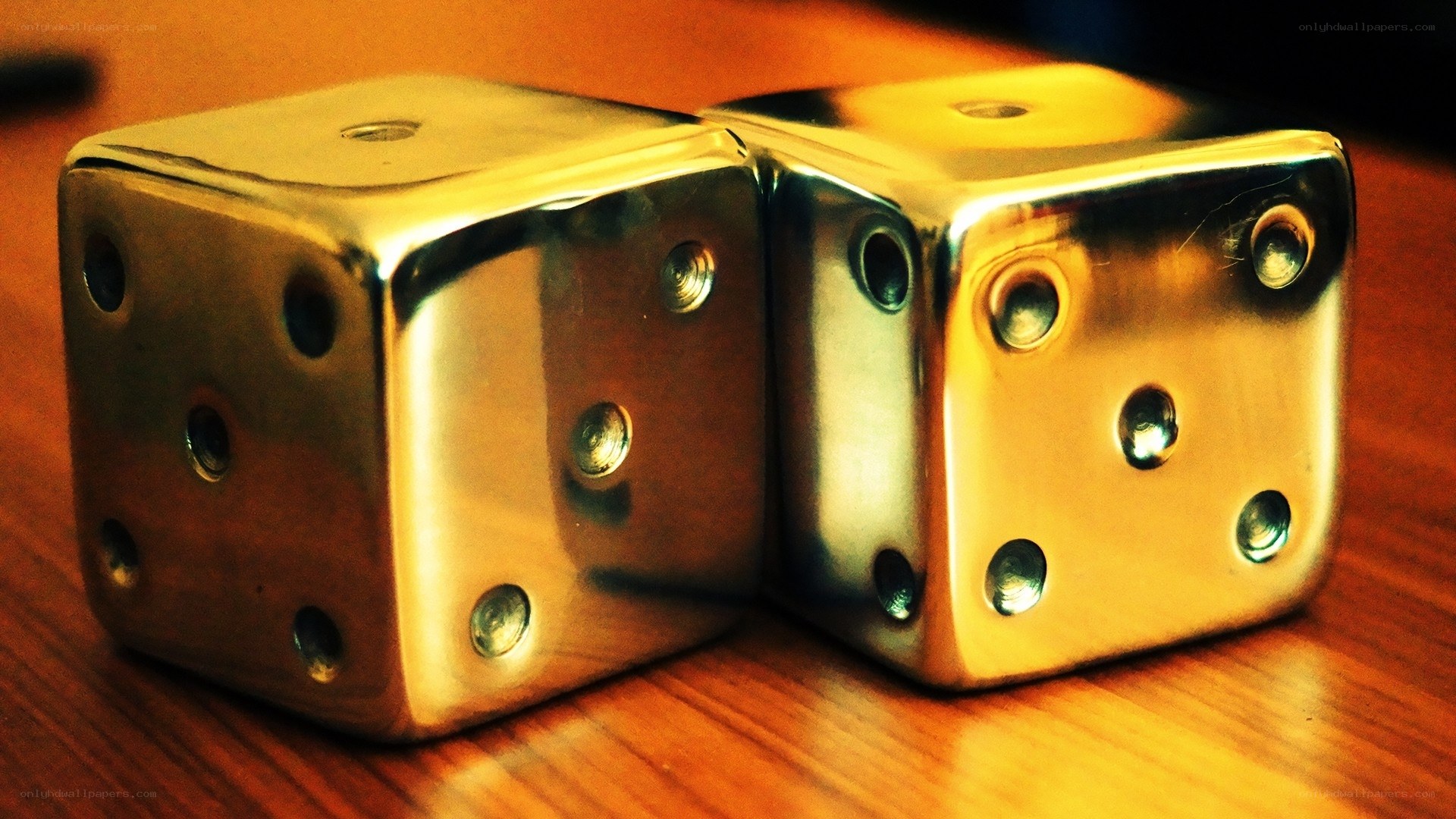 Metal dice on wooden table