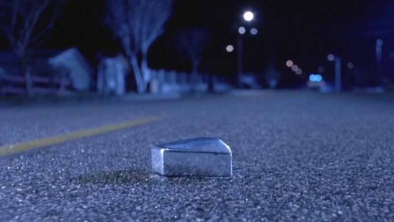 metal object on road at night