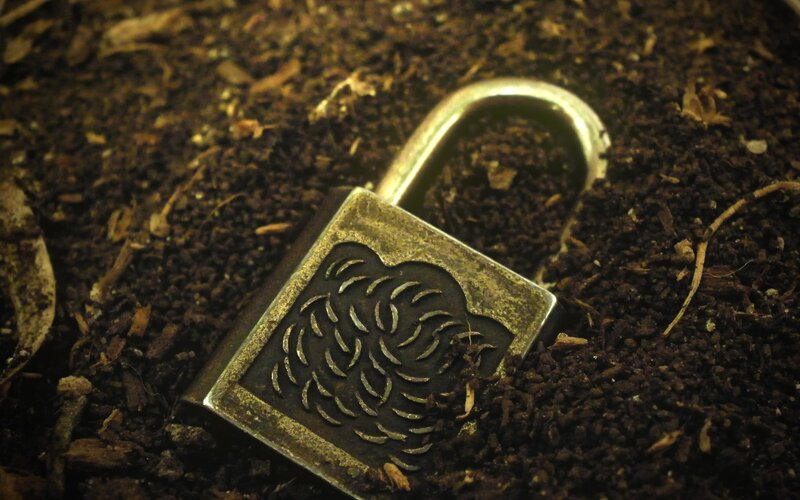 Metal Padlock in Soil