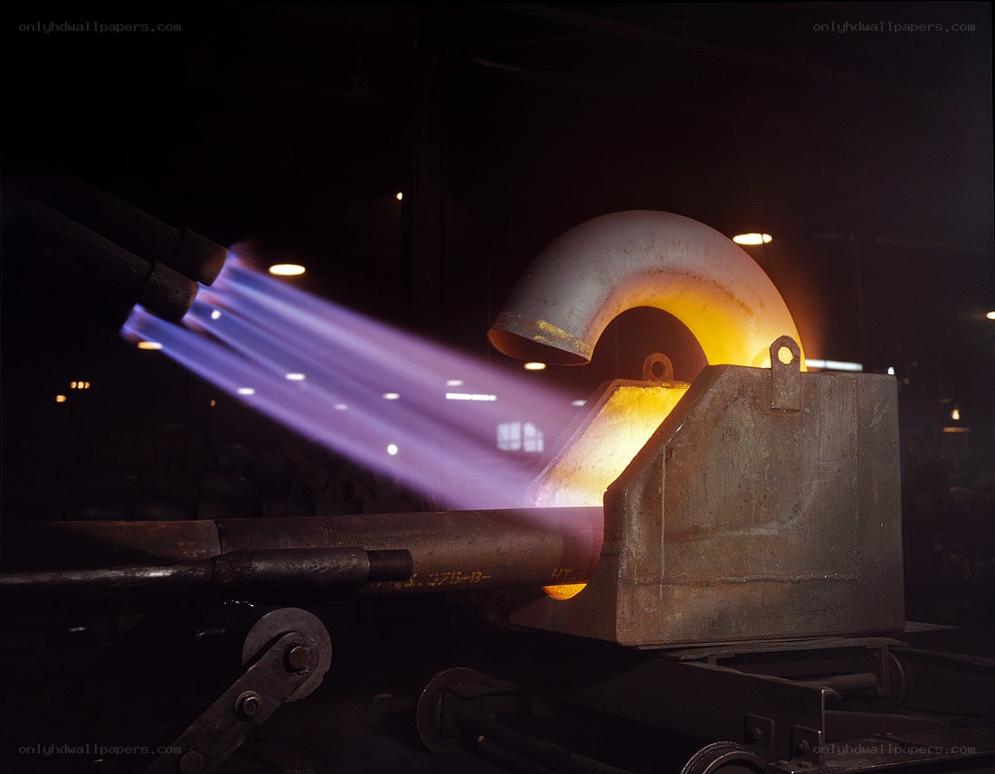 Metal pipe being heated in factory
