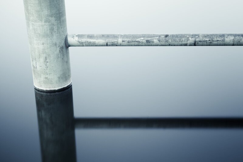 metal railing on calm water