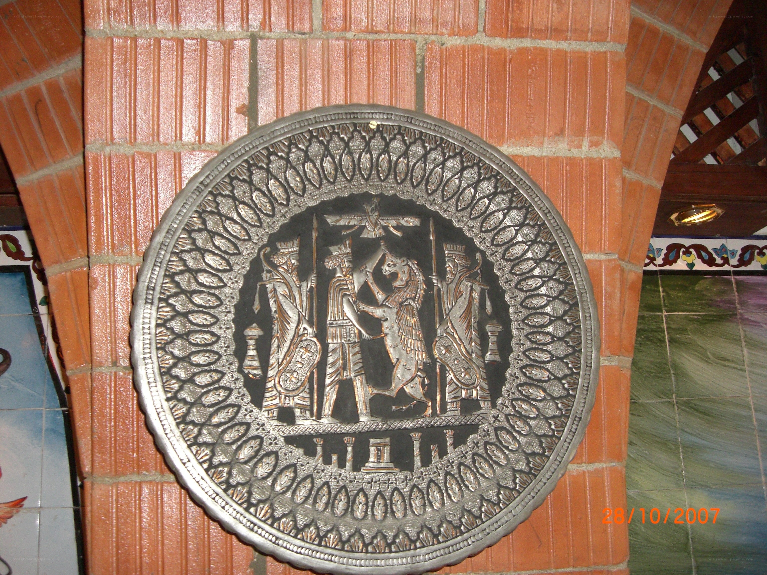 metal relief on brick wall
