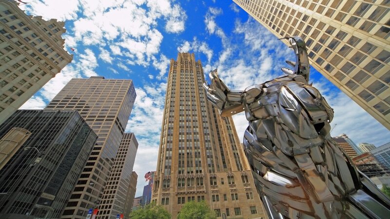 Metal sculpture in city skyline