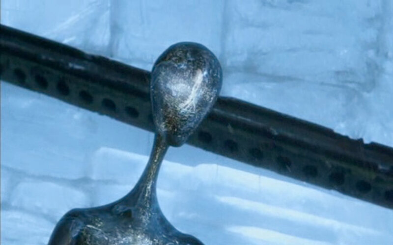 metal sculpture of alien figure