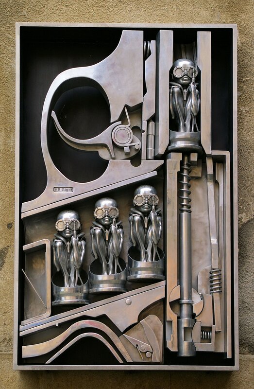 metal sculpture with alien figures