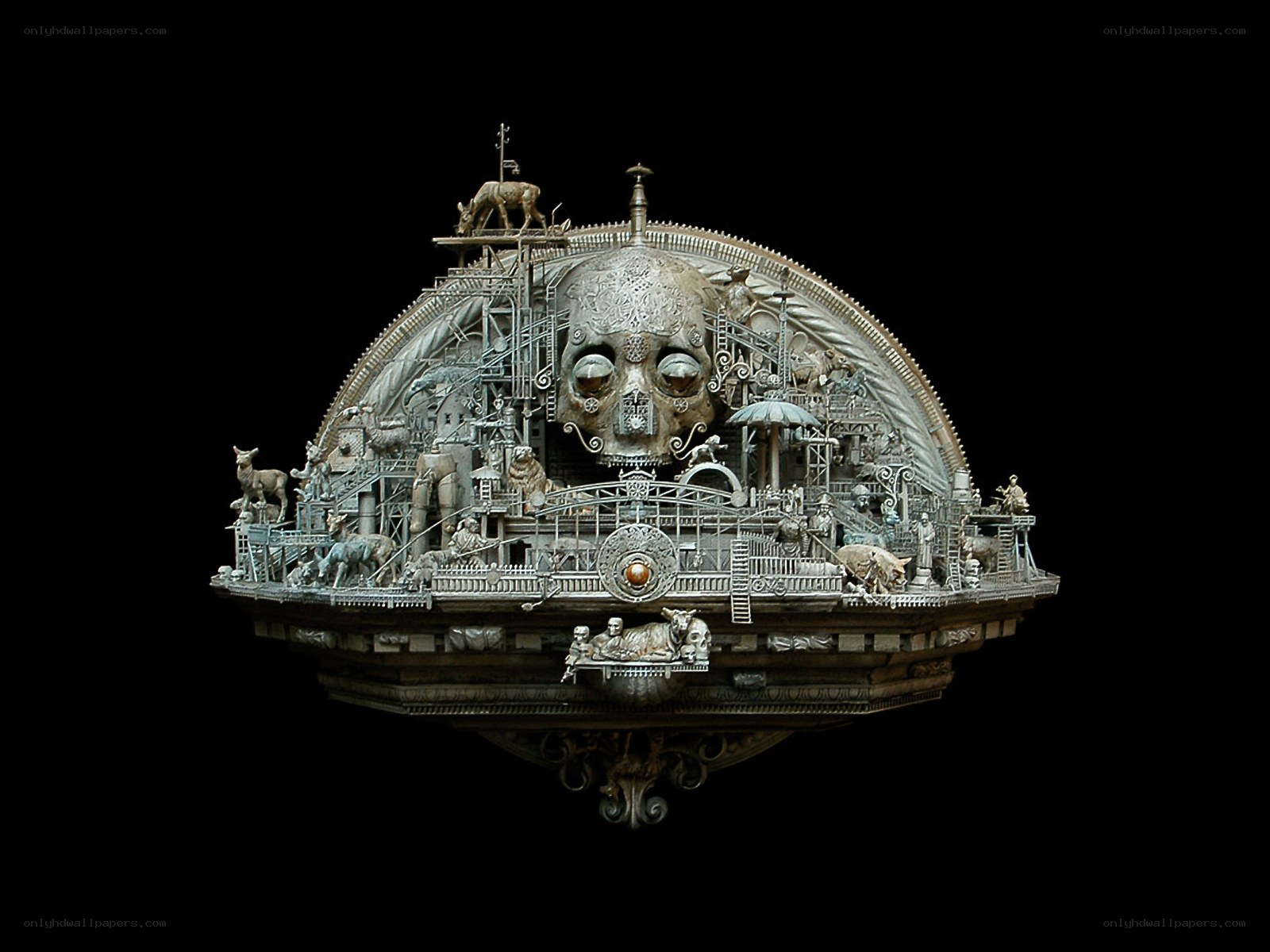 Metal skull sculpture with figures