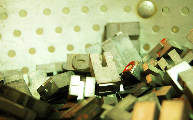 metal type blocks in a tray