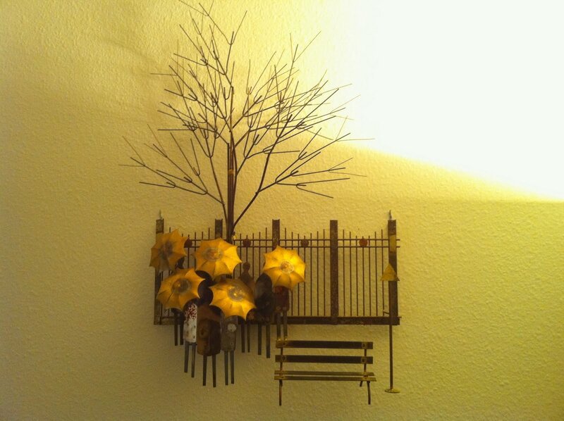 Metal wall art with tree and bench