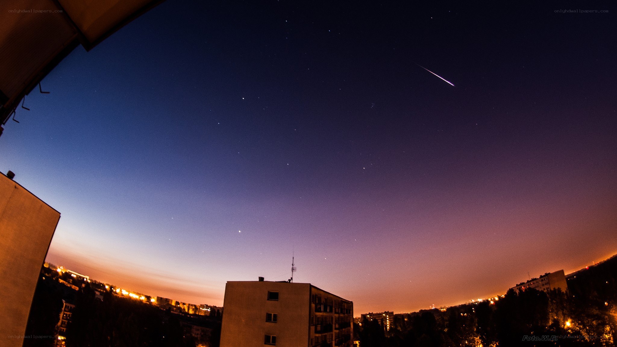 Meteor over city at night