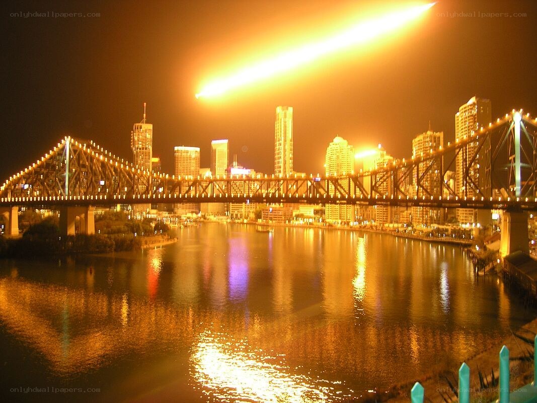 Meteor over city bridge
