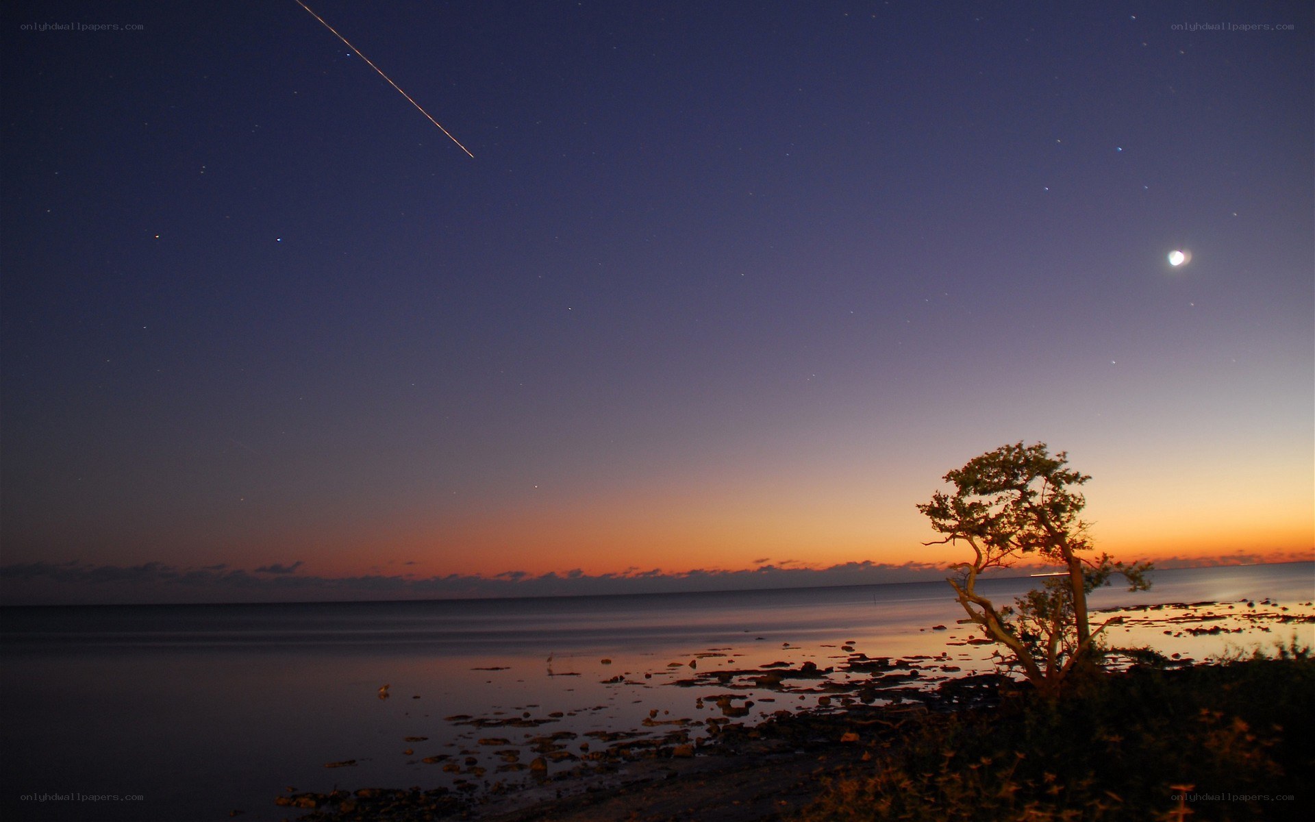 Meteor over coastal sunset