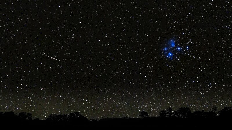 Meteor over starry sky