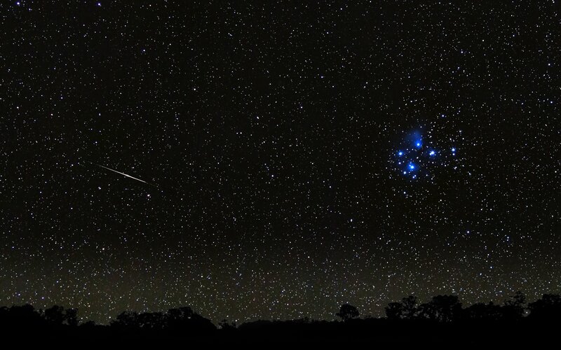 Meteor over starry sky