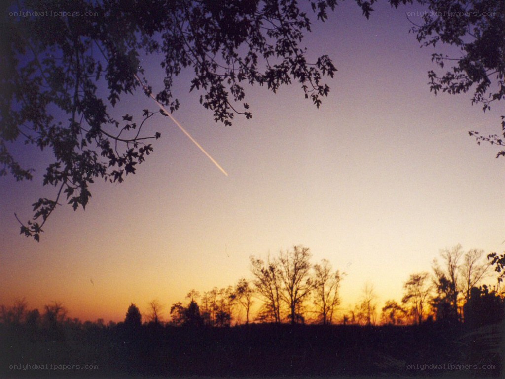 Meteor over sunset landscape