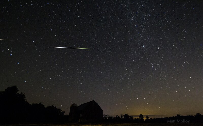 Meteor shower over a barn