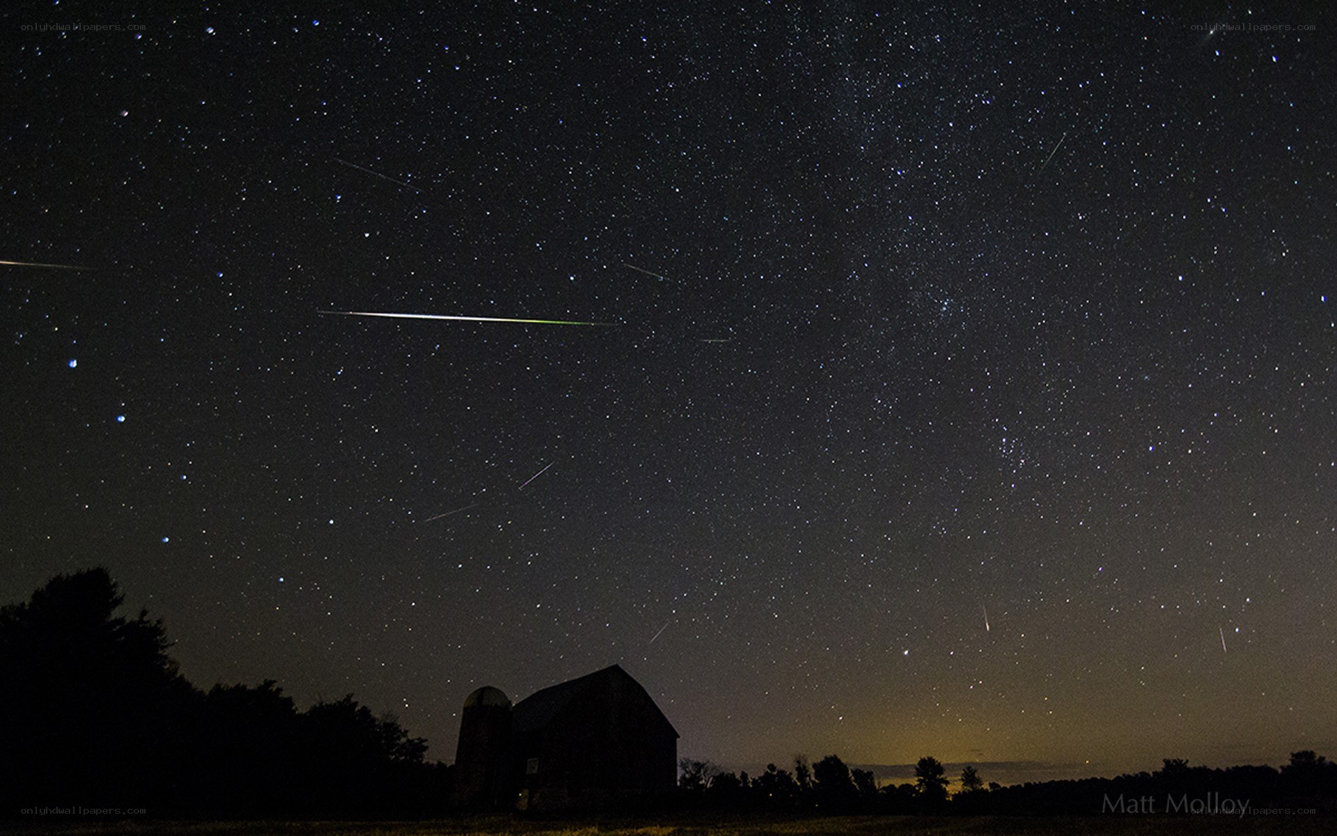 Meteor shower over a barn
