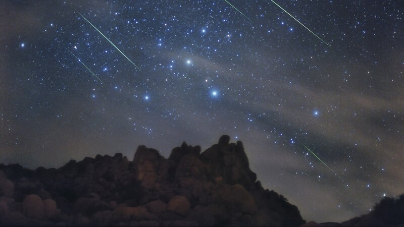 Meteor shower over rocky landscape
