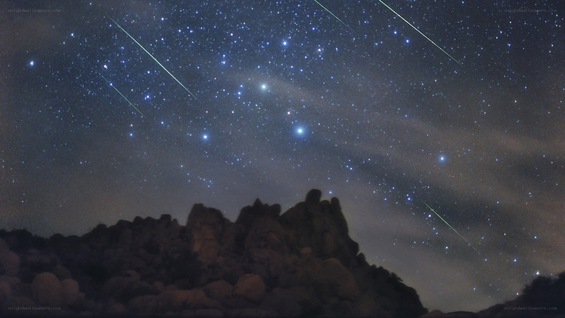 Meteor shower over rocky landscape