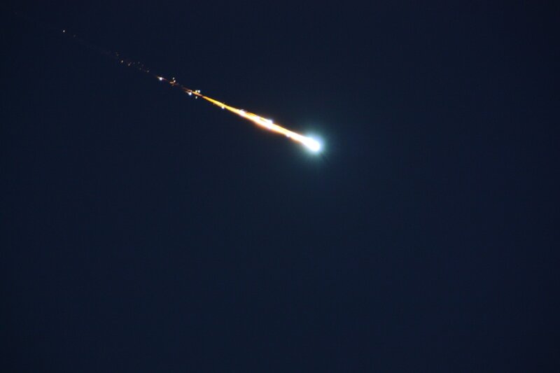 Meteor streaking across night sky