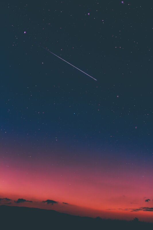 Meteor Streaking Across Sky — Dark Blue