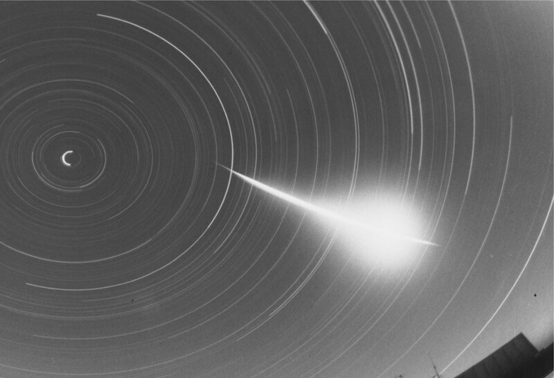 Meteor streaking through star trails