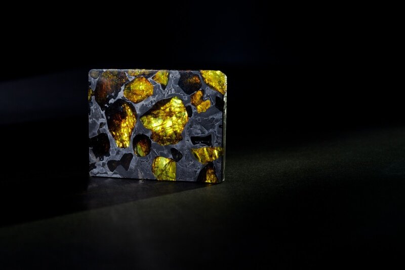 meteorite specimen on black background