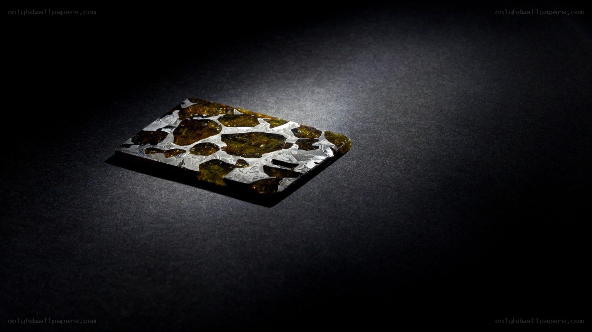 meteorite specimen on dark surface