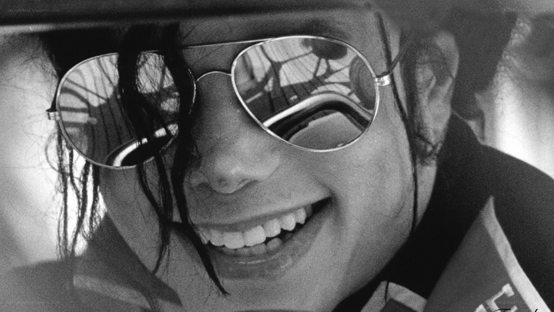 Michael Jackson smiling in sunglasses