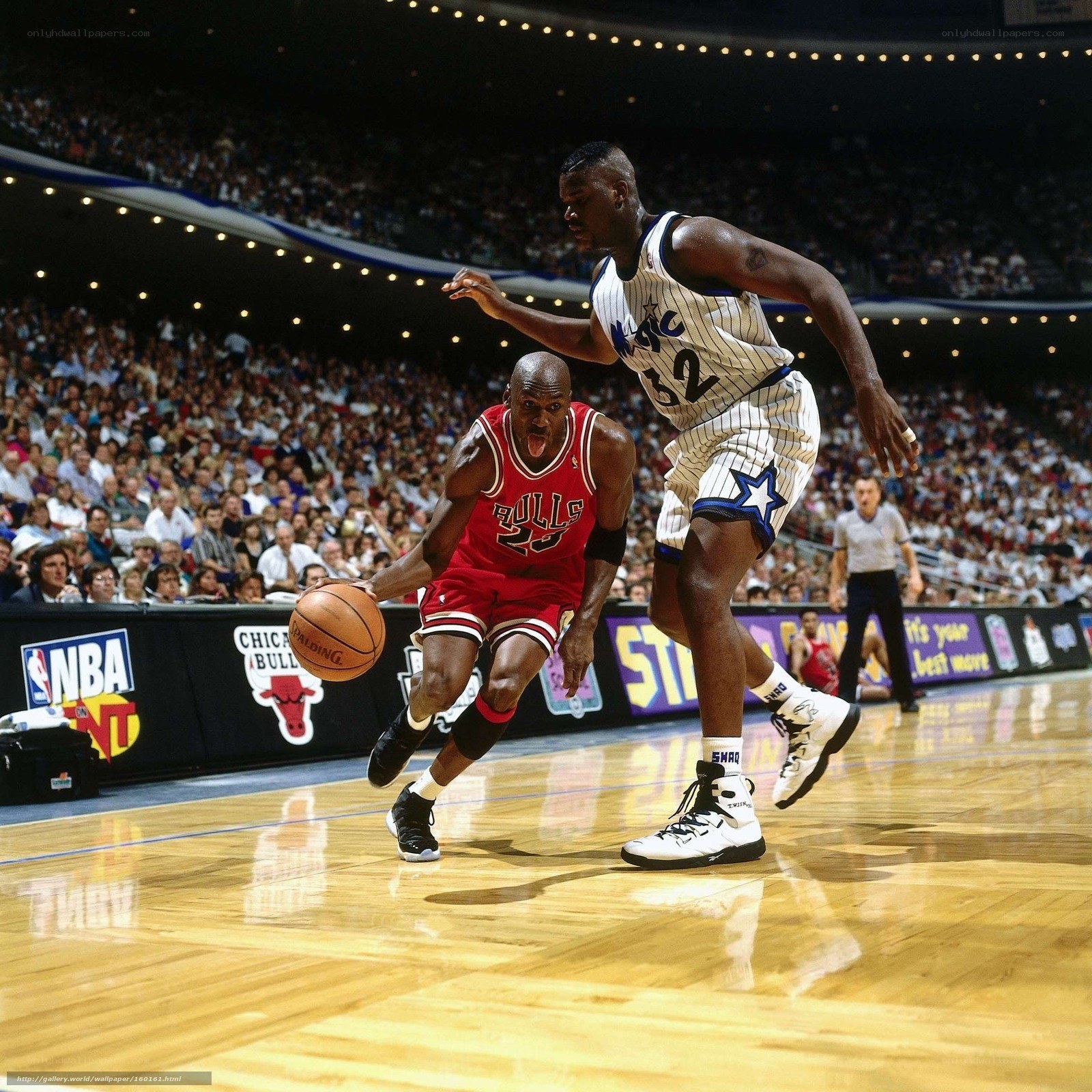 Michael Jordan drives past Shaquille O'Neal