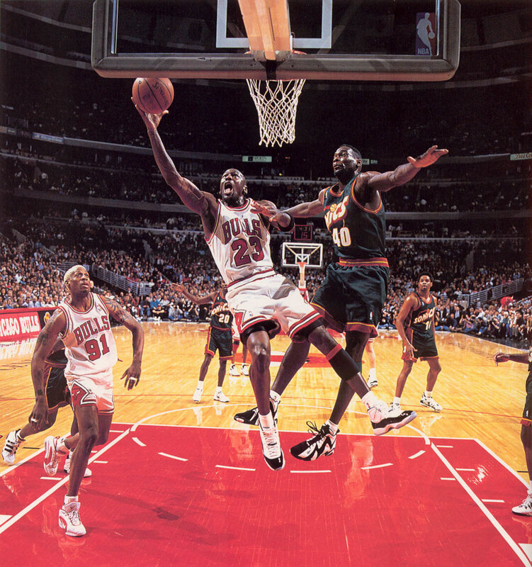 Michael Jordan dunks over defender