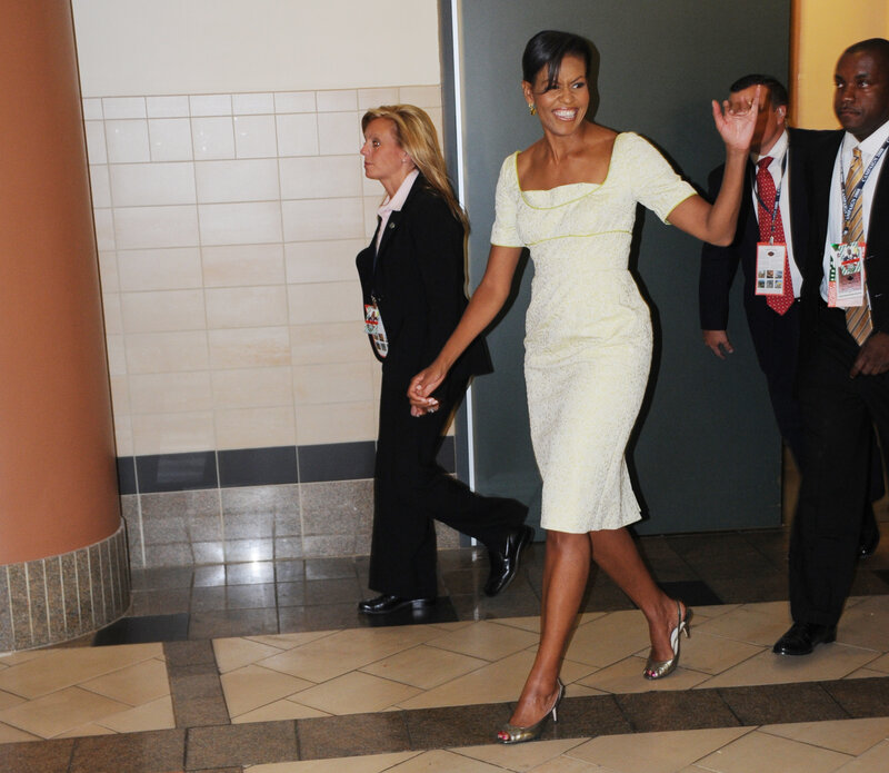 Michelle Obama waves while walking