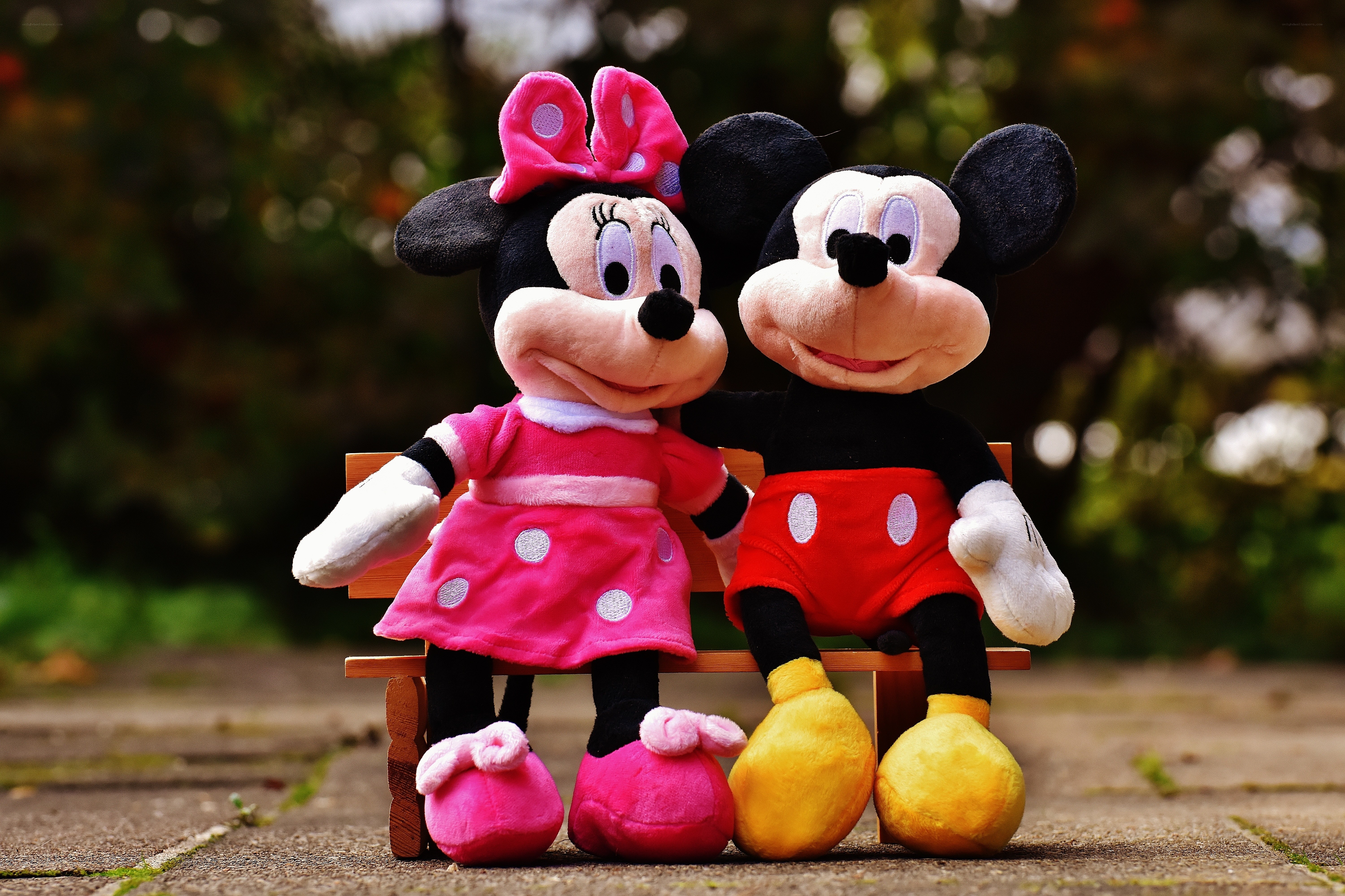Mickey and Minnie plush on bench