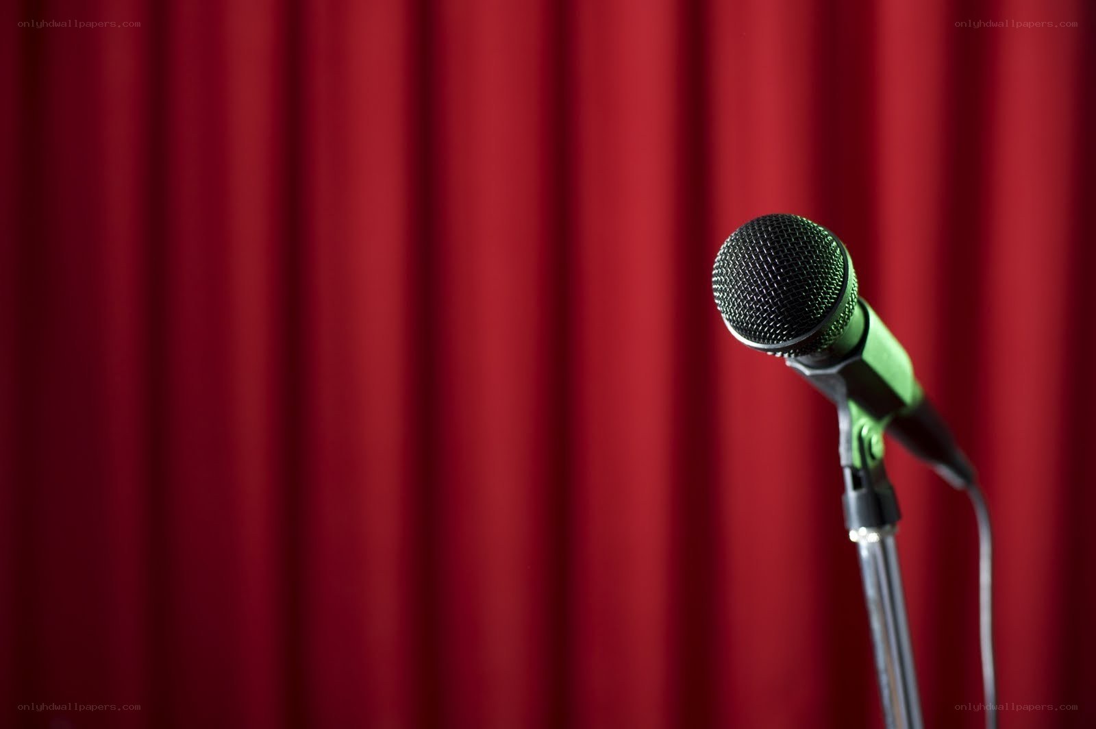 microphone on stage with red curtain