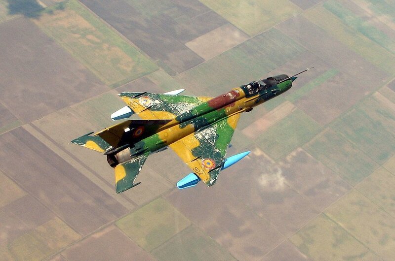 MiG-21 in flight over farmland